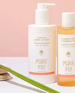 Collection of Pure Fiji skincare products on a light pink background